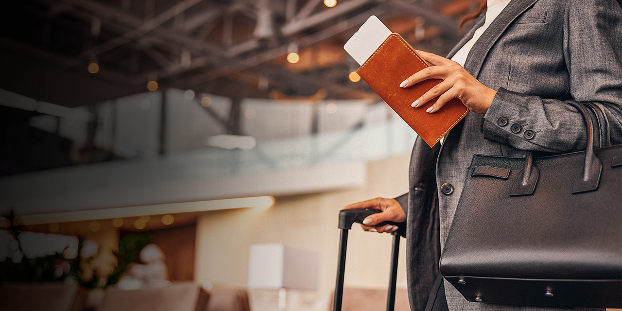 Close up of elegant lady with airplane ticket standing by the table with coffee cup and book stock photo