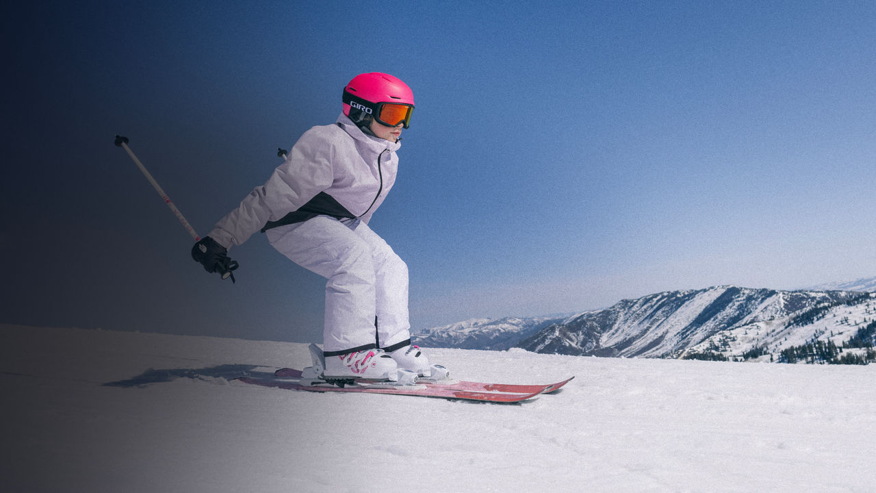 A skiier riding down a slope