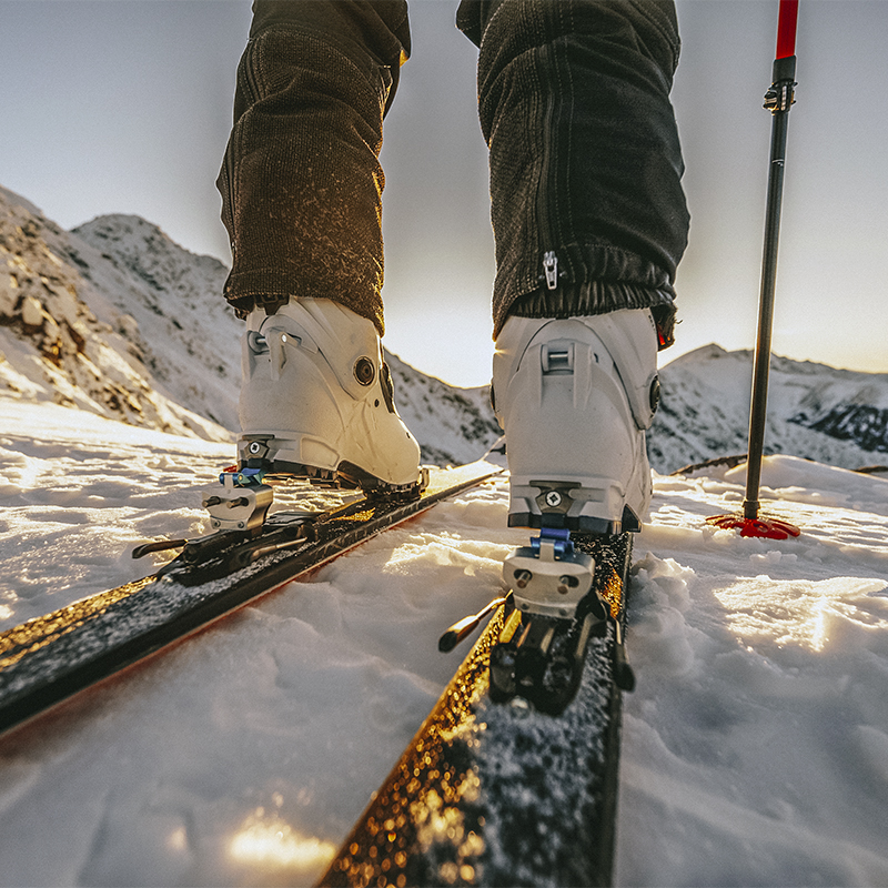 Detail of a backcountry skiers skis and boots in the mountains. 