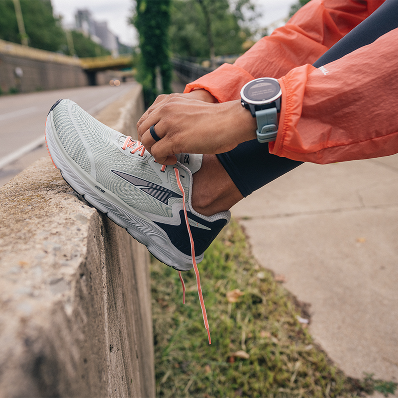 Tight shot of a runner tying her shoes