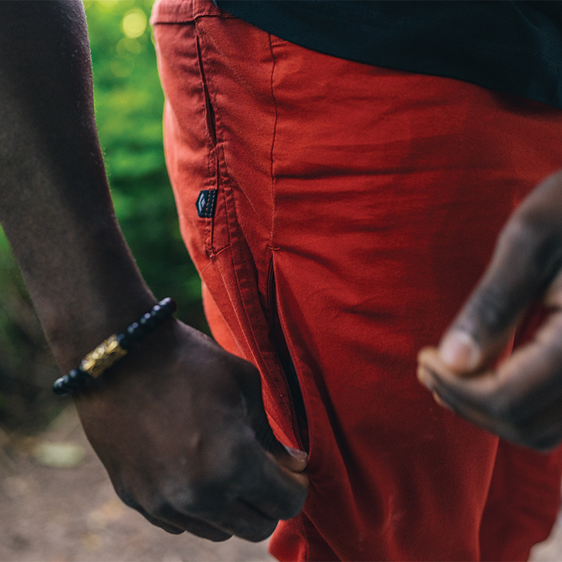 A close up image of a pocket on orange pants.