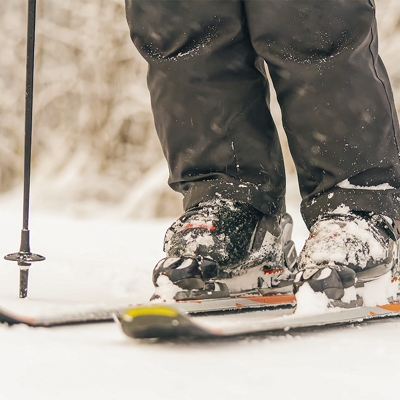 Close up on snowy skis and ski boots