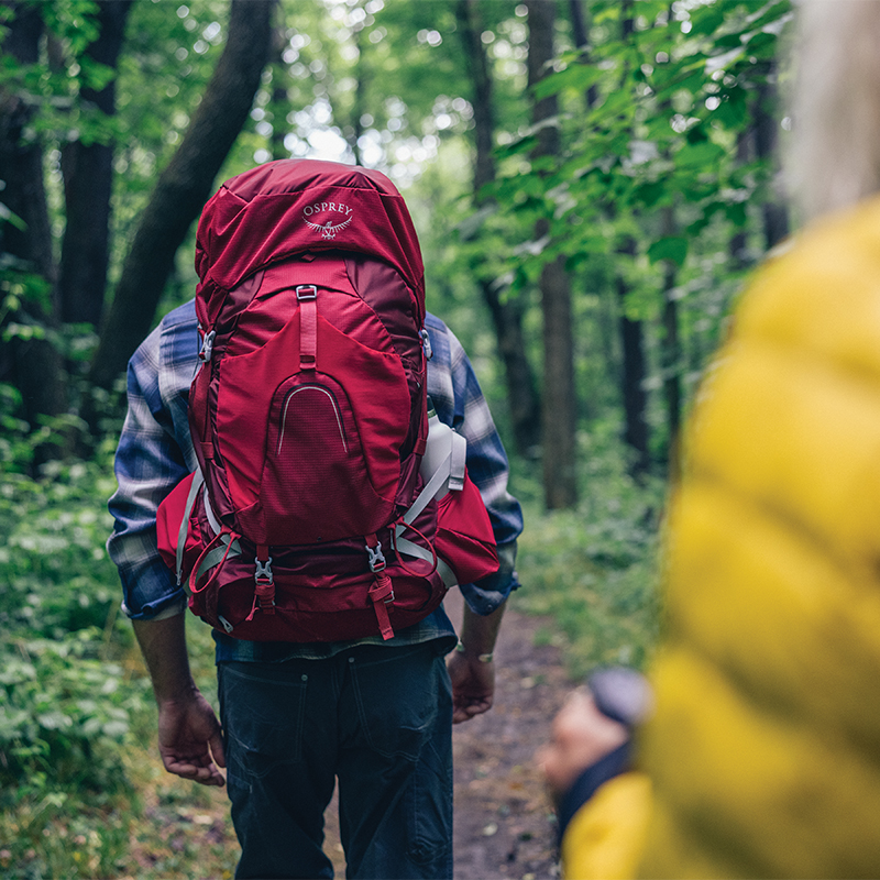 Hiker wearing an Osprey backpack on a trail