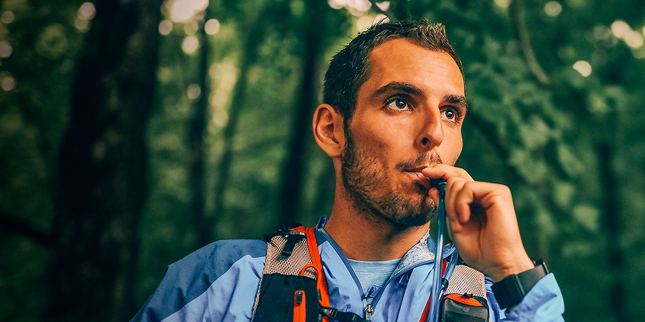 A person drinking out of a hydration reservoir