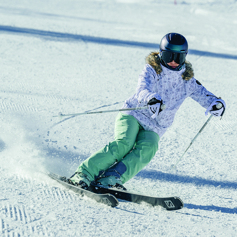 A woman skis down a mountain