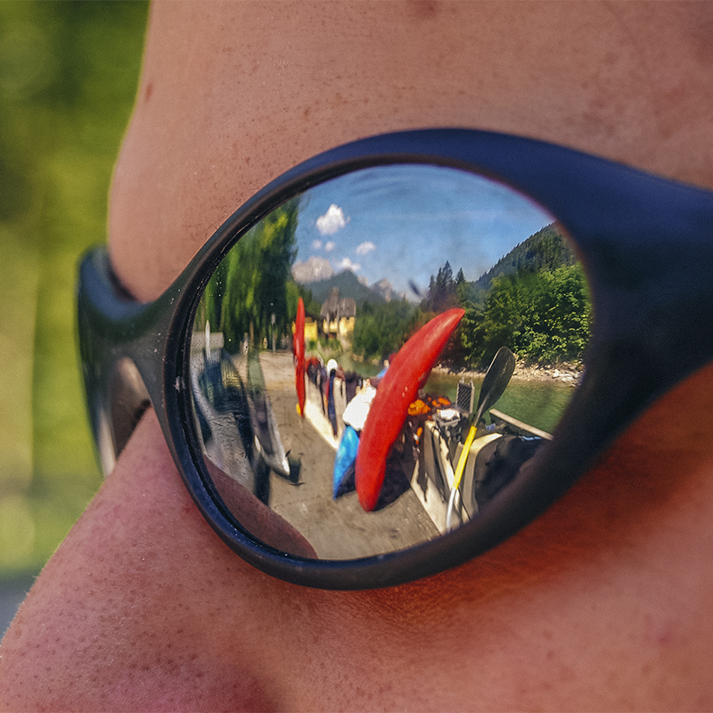 A kayak reflected in a persons sunglasses