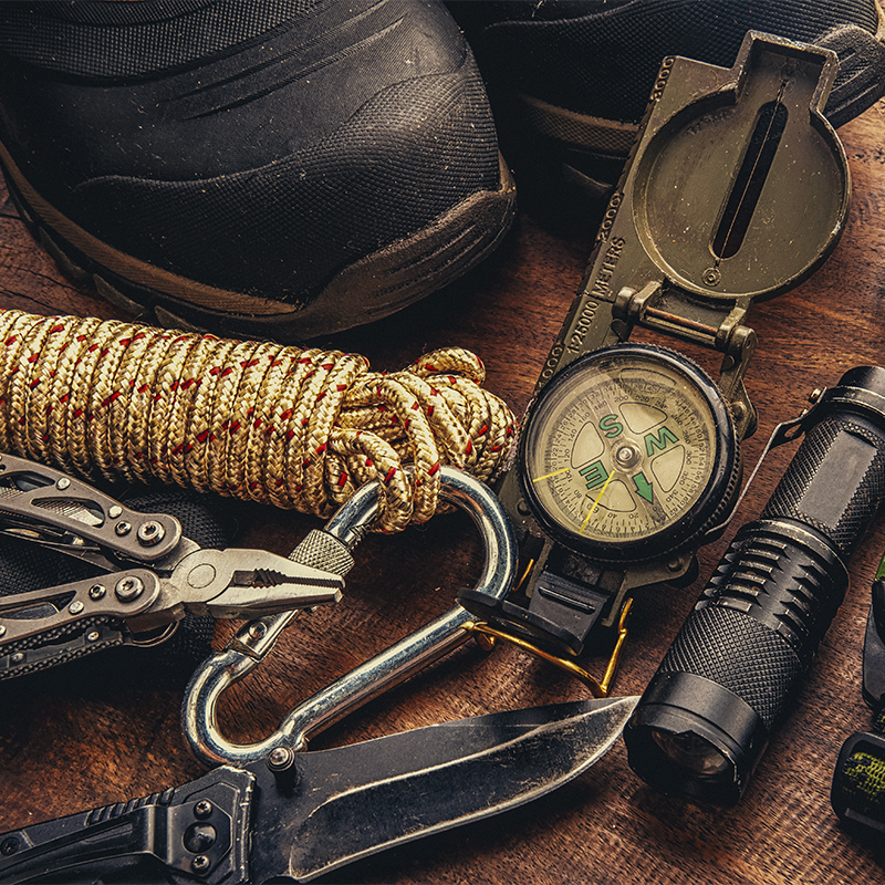 Outdoor survival gear including a compass, a rope and a knife