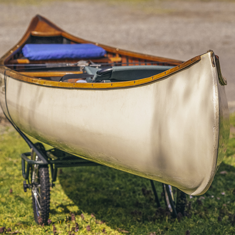 Canoe strapped to a cart to transport it to a lake.