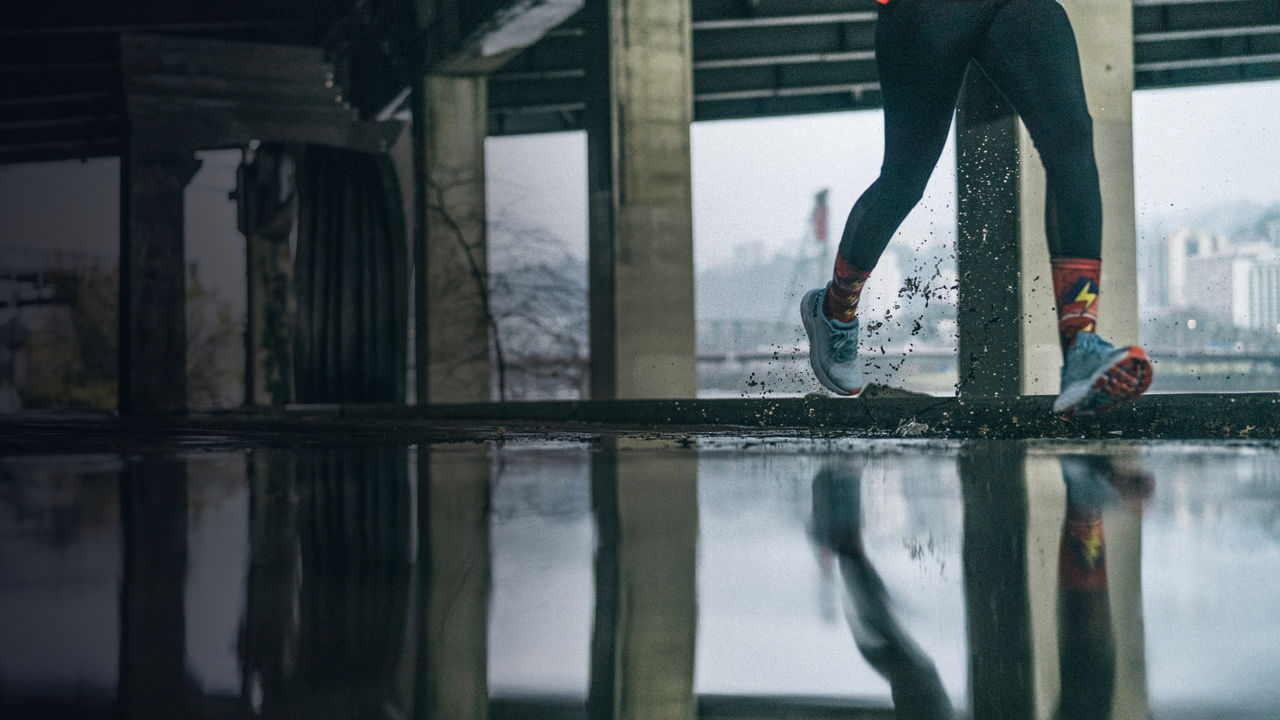 A close up of a runner through puddles