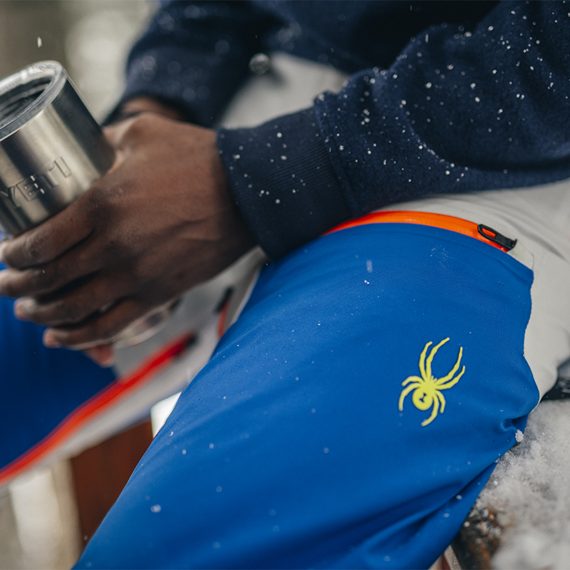 Detail of a mans snow pants with a spider