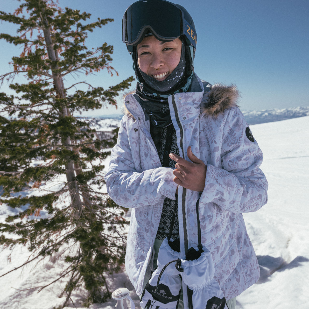 A skier wears a face mask