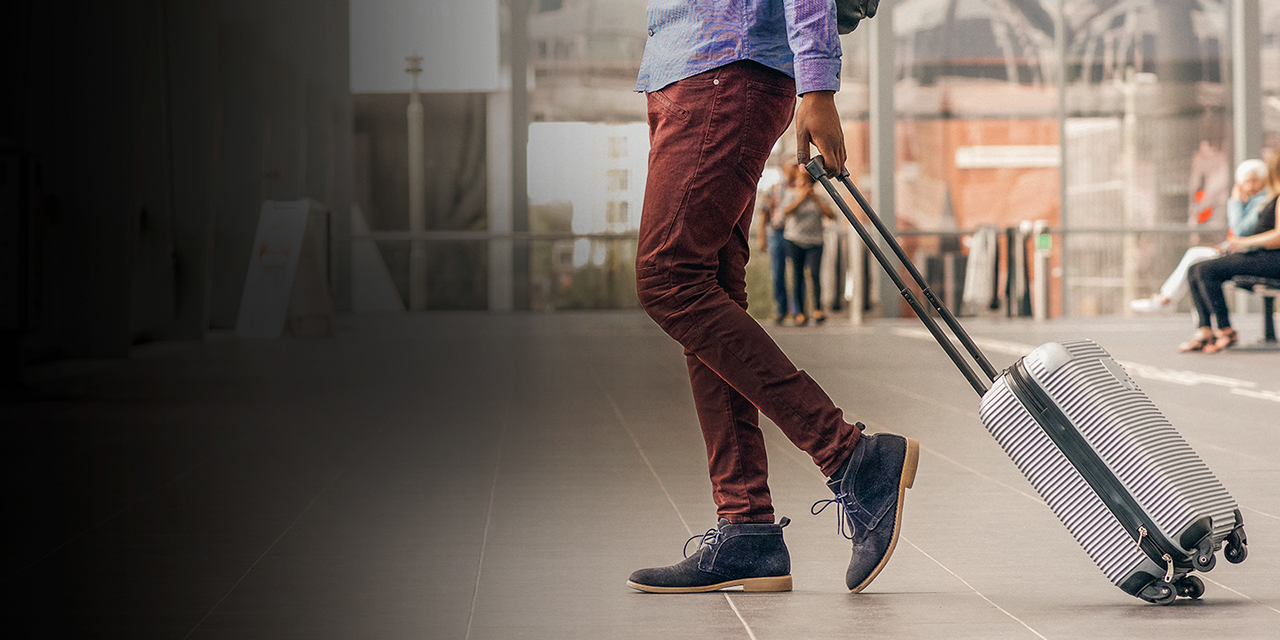 A man traveling with suitcase at the airport 