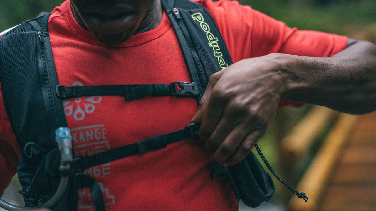 A man adjusts his water bladder pack