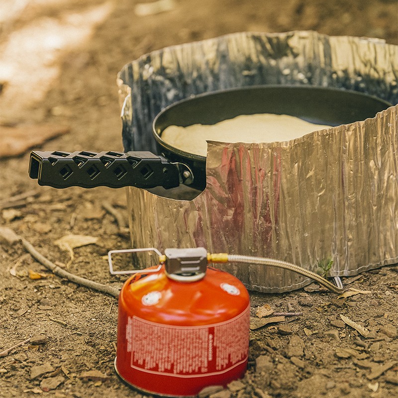 Food being prepared on a camping trip with small camping sized equipment