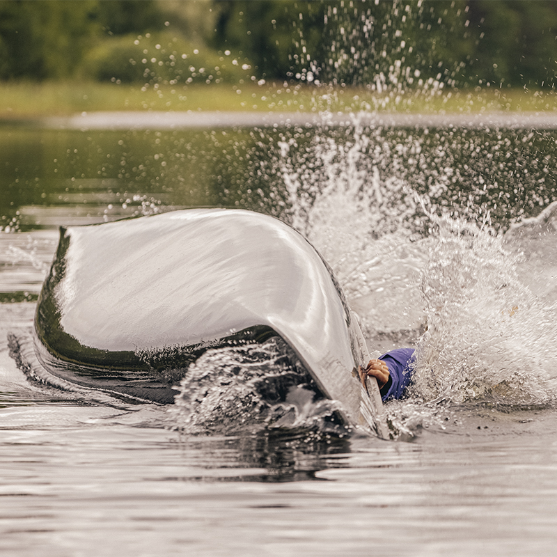 A canoe capsizes in the water