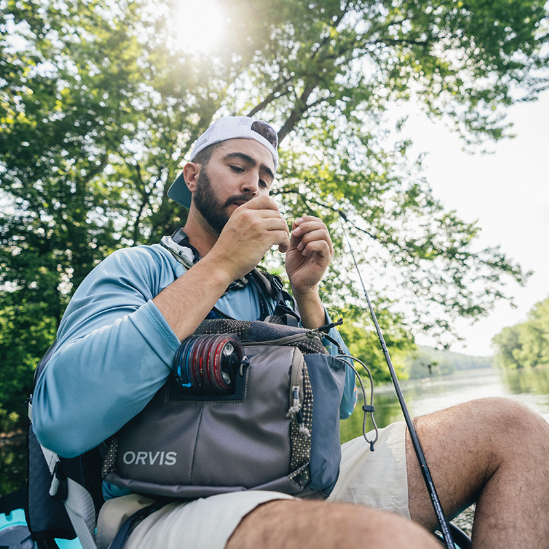 a man fixing his fishing hook