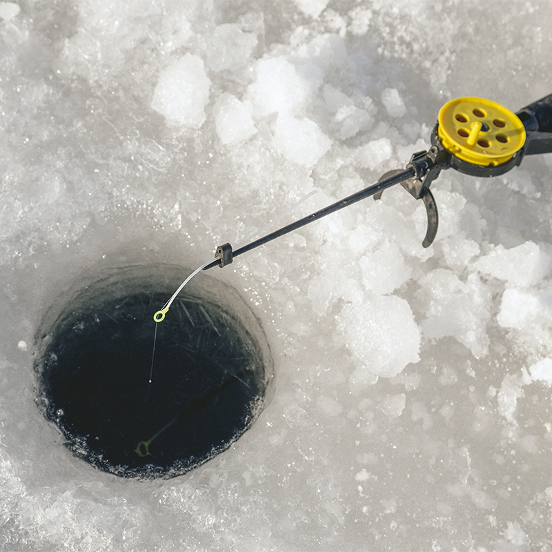 An ice fishing pole in an ice hole