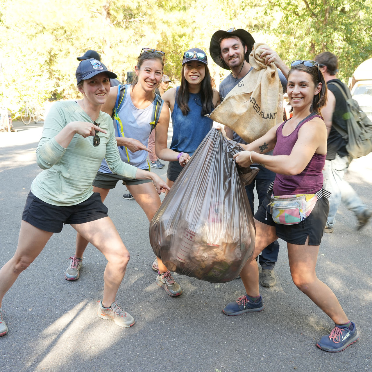 Volunteers show trash they have picked up