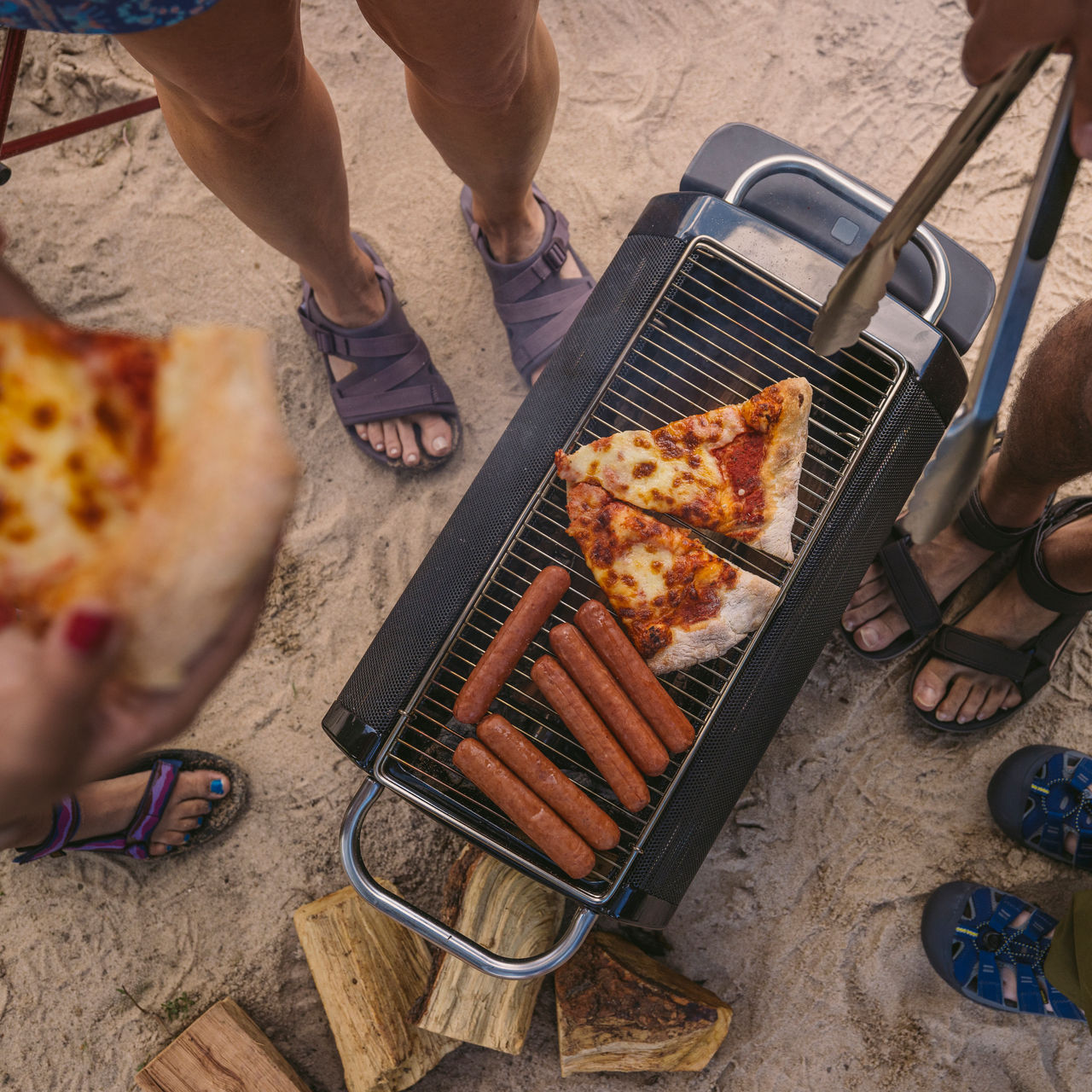 A group cooks on an outdoor grill
