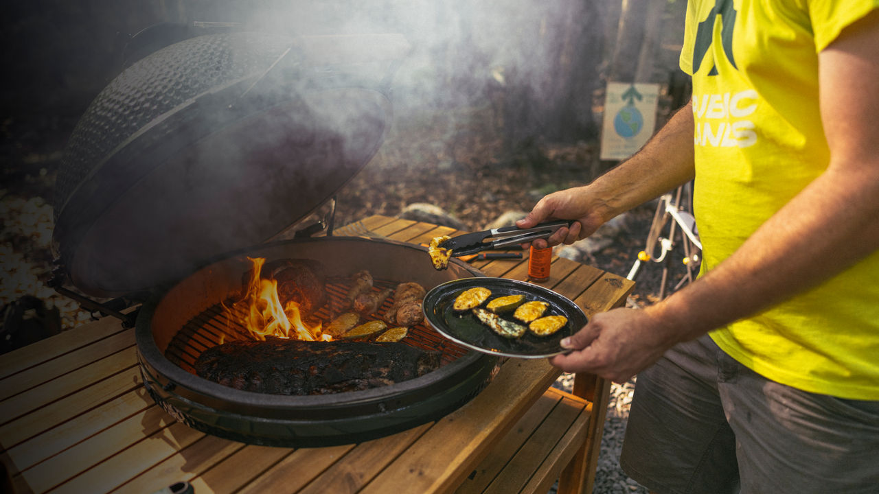 A man grills outside