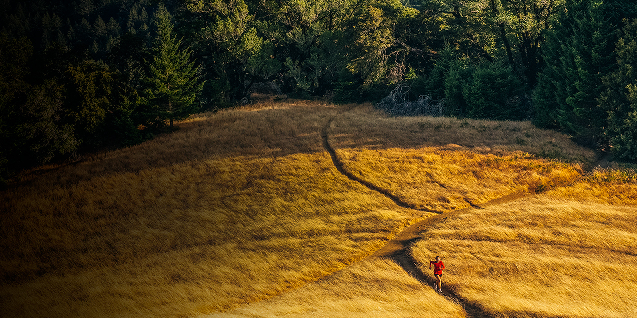 Angela on a late afternoon trail run near Pan Toll Station on the slopes of Mt Tam in Marin County, California. The Marin Headlands and a foggy Pacific Ocean are in the distance.