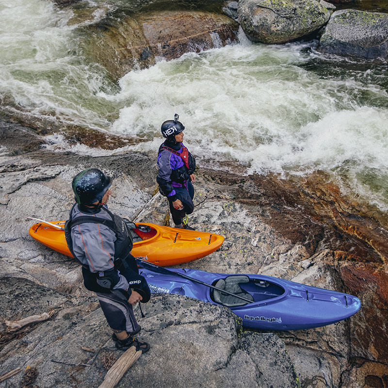 Two kayakers looking over on the South Silver river in Northern California. 