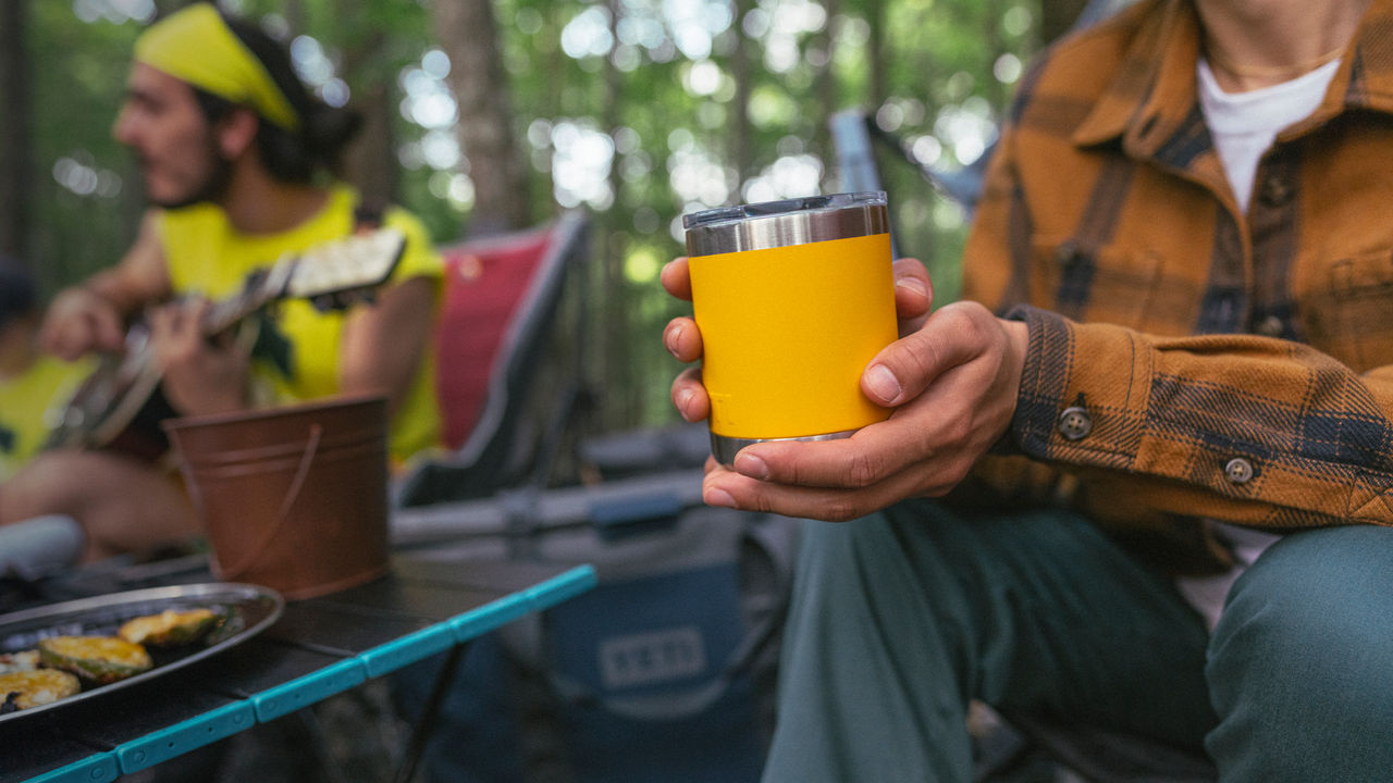 A man drinks out of a camping cup