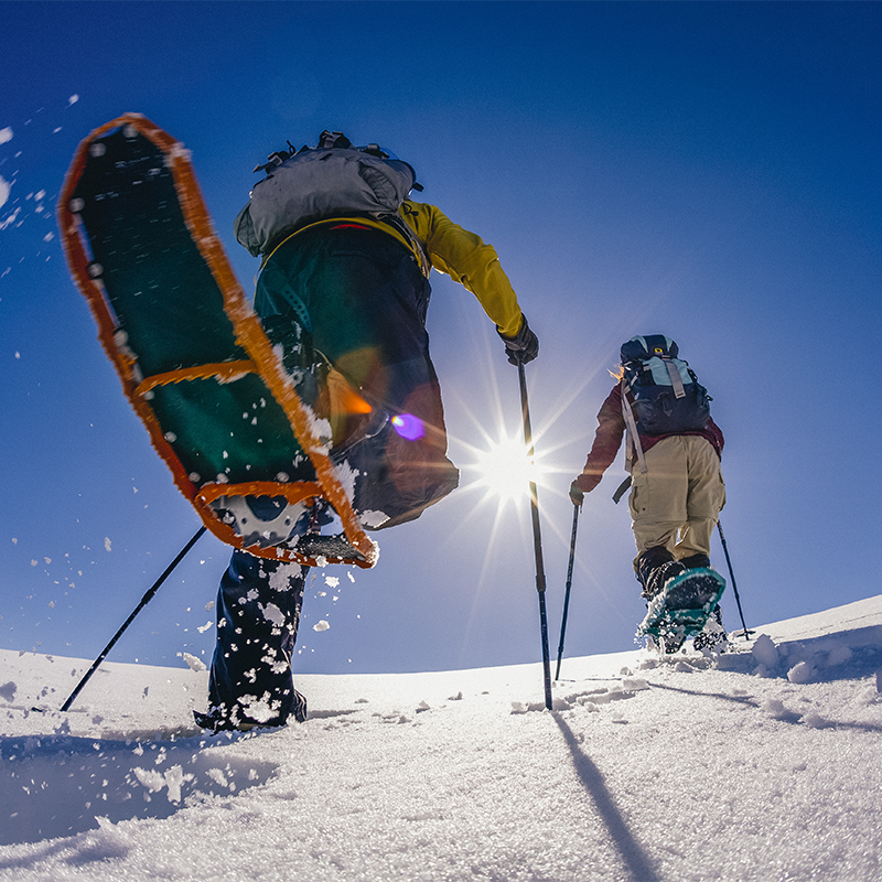 A young man and woman snowshoeing in Paradise Valley, Mt. Rainier National Park, Washington