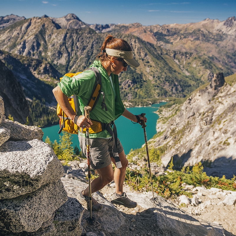 A women begins the long descent from the top of Asgard Pass, high above Colchuck Lake in the surrel setting of the  Enchantments Wilderness Area in the Central Cascades, near Leavenworth, WA.