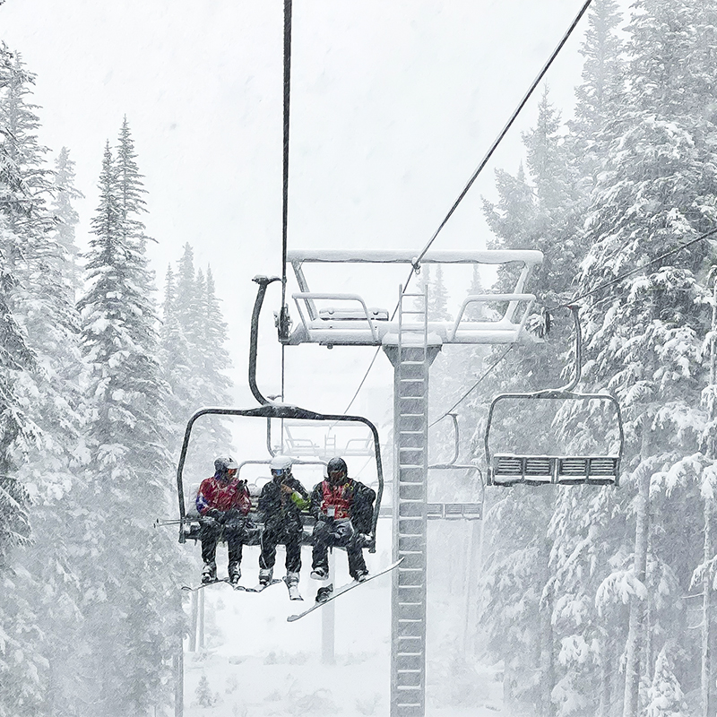 Skiiers on a lift at Sunrise Park Resort