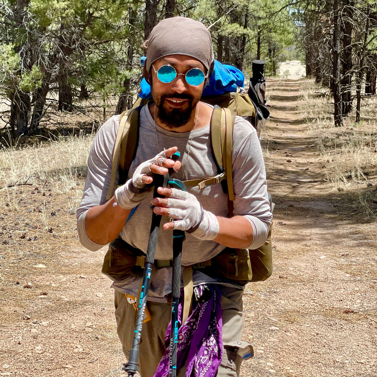 Derick Lugo smiles for a photo on the trail
