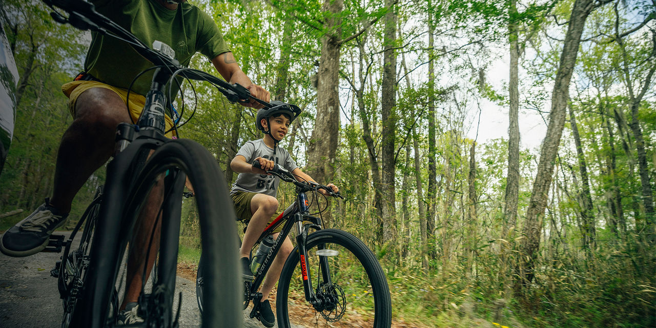 A father and son mountain biking