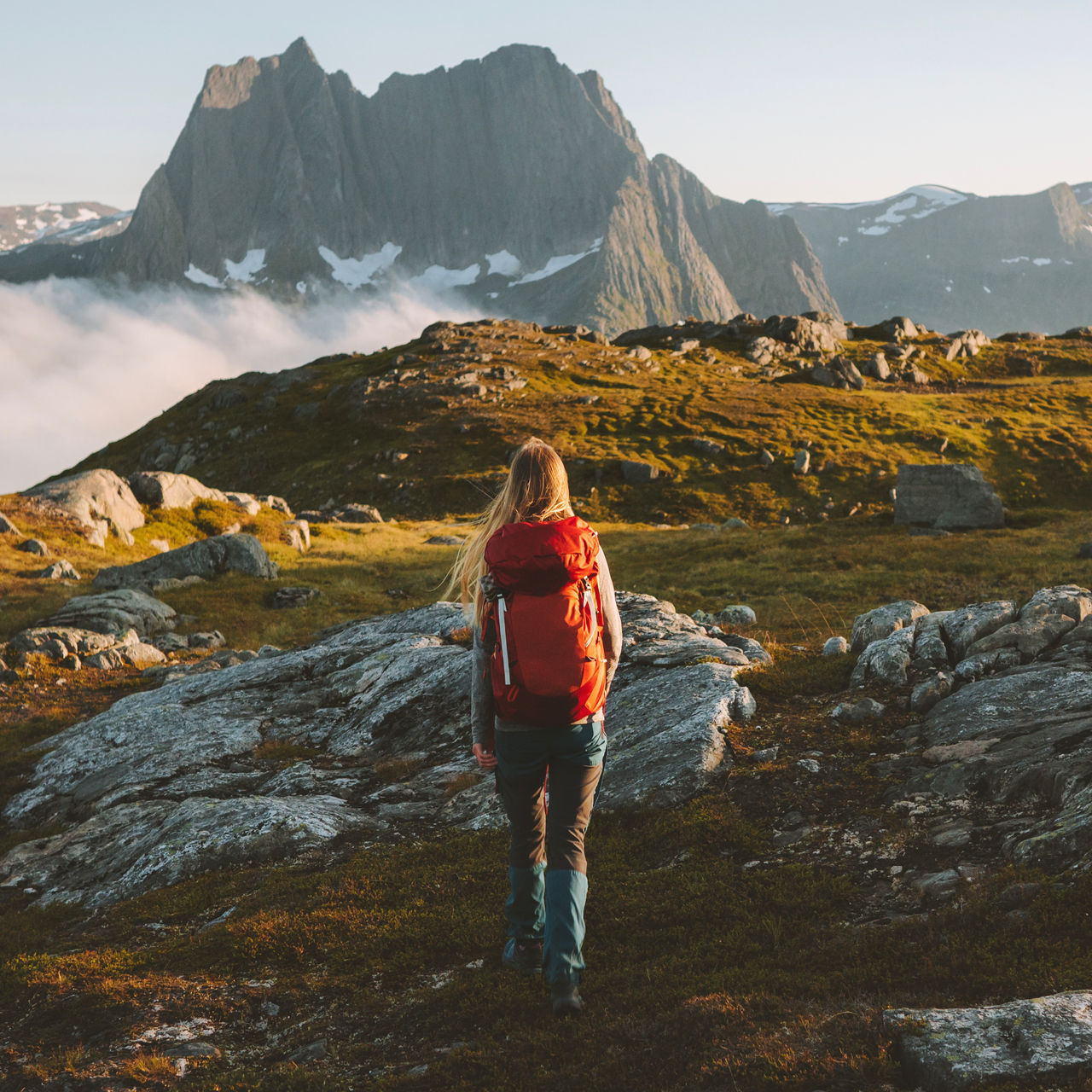 Woman hiking in mountains with backpack 