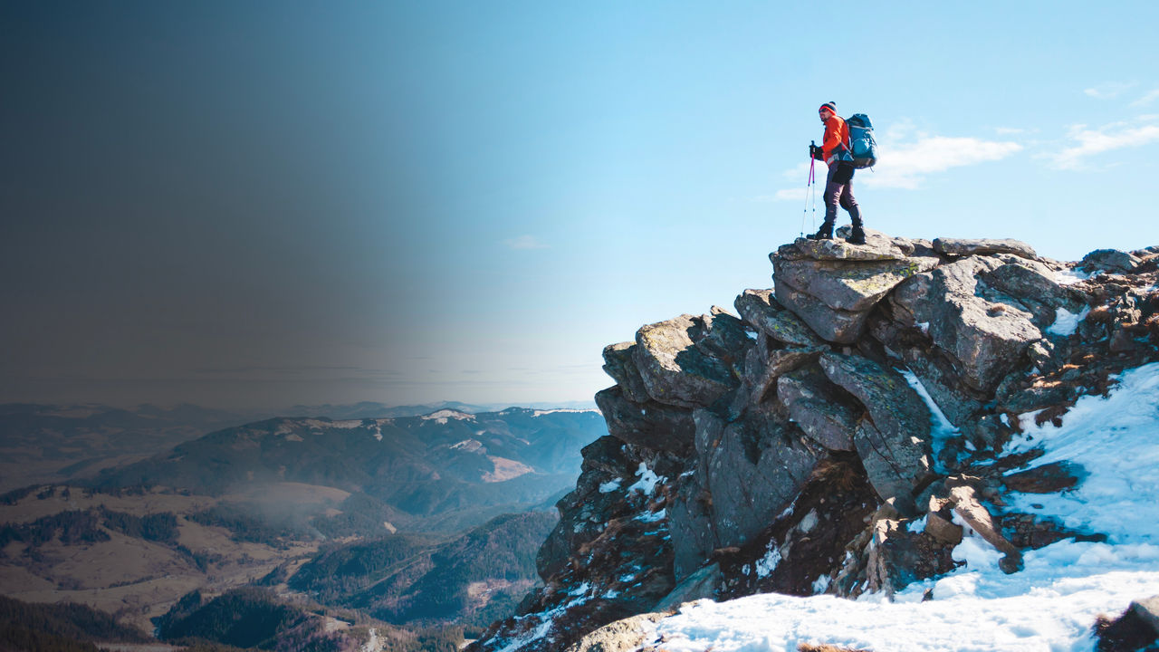 Mountaineer with a backpack on a mountain 