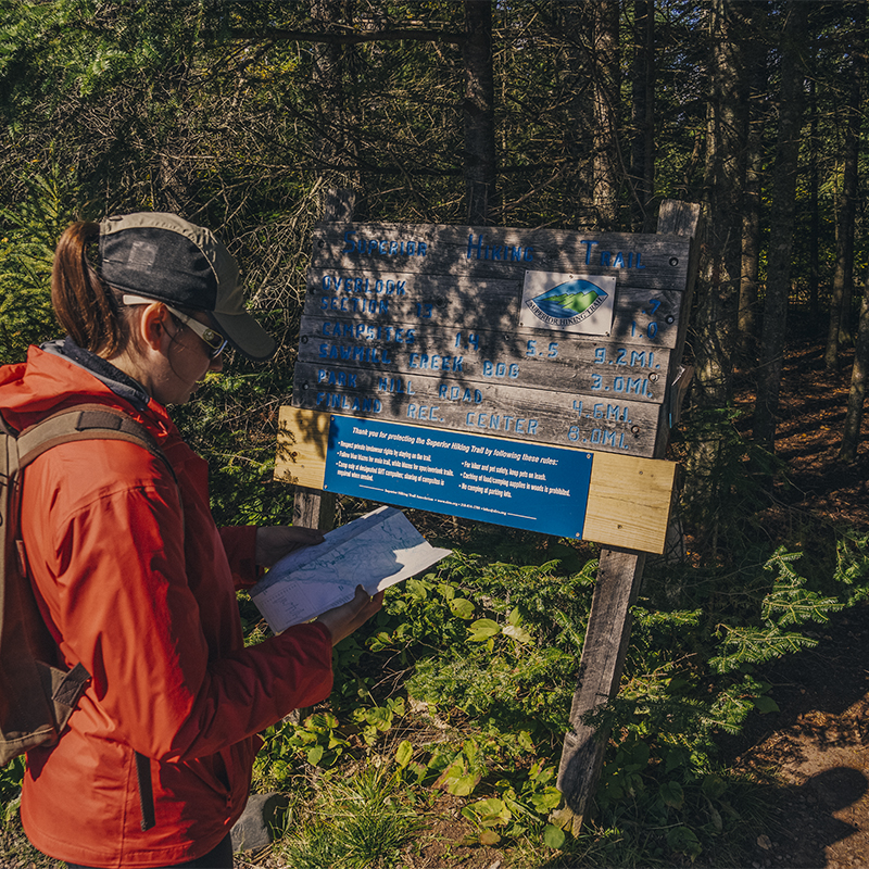 A woman hikes Section 13 of the Superior Hiking Trail along Minnesota's North Shore of Lake Superior.