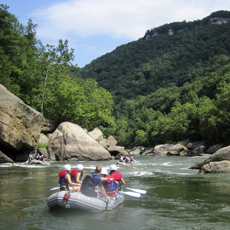 Whitewater rafters enjoy a scenic stretch of river at New River Gorge National Park. 