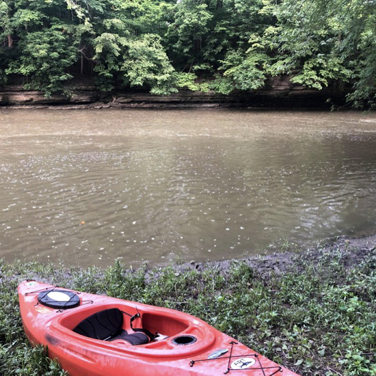 A kayak on the shore of the river at Sycamore Run Park.