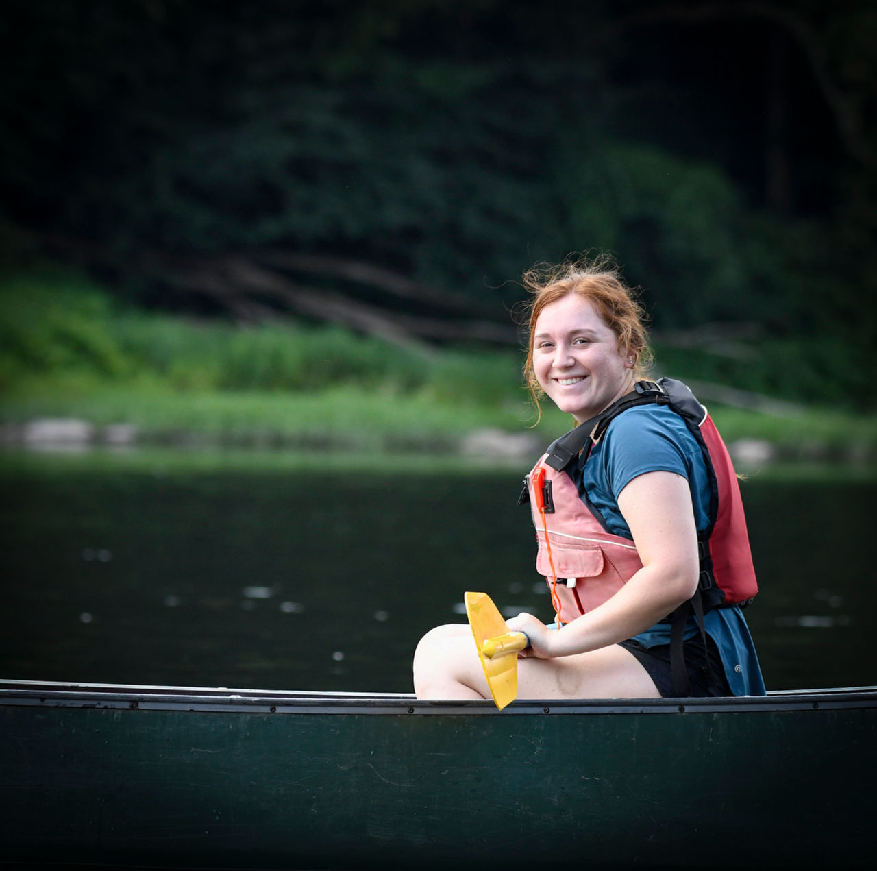 A paddler smiles for the camera while canoeing on the Delaware River.