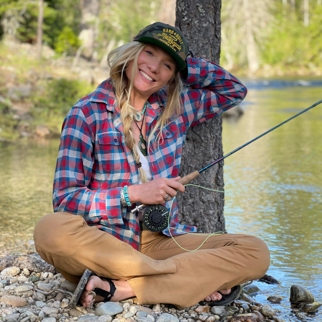 Mandela van Eeden poses with her fishing rod by the river