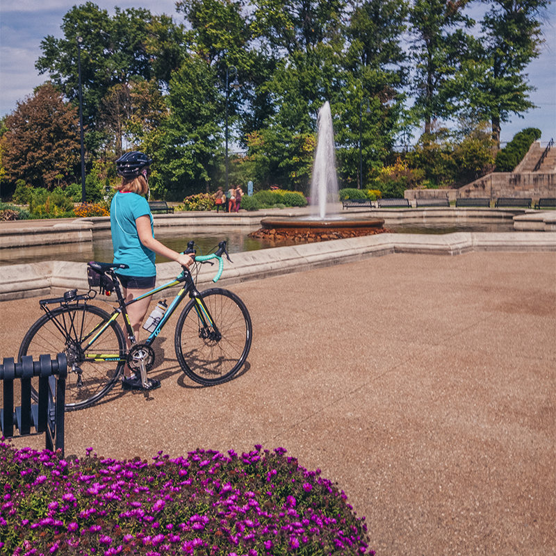 A person with a bike looks on at Highland Park 