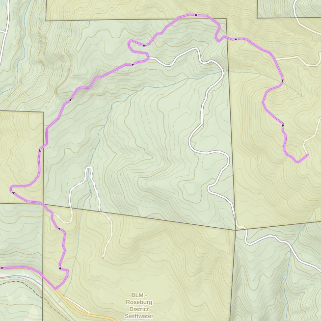 The pink line shows the route to the yellow gate from Highway 138. The red waypoint indicates the position of North Comb. Be sure to camp within BLM land (the gold boxes on the map). 