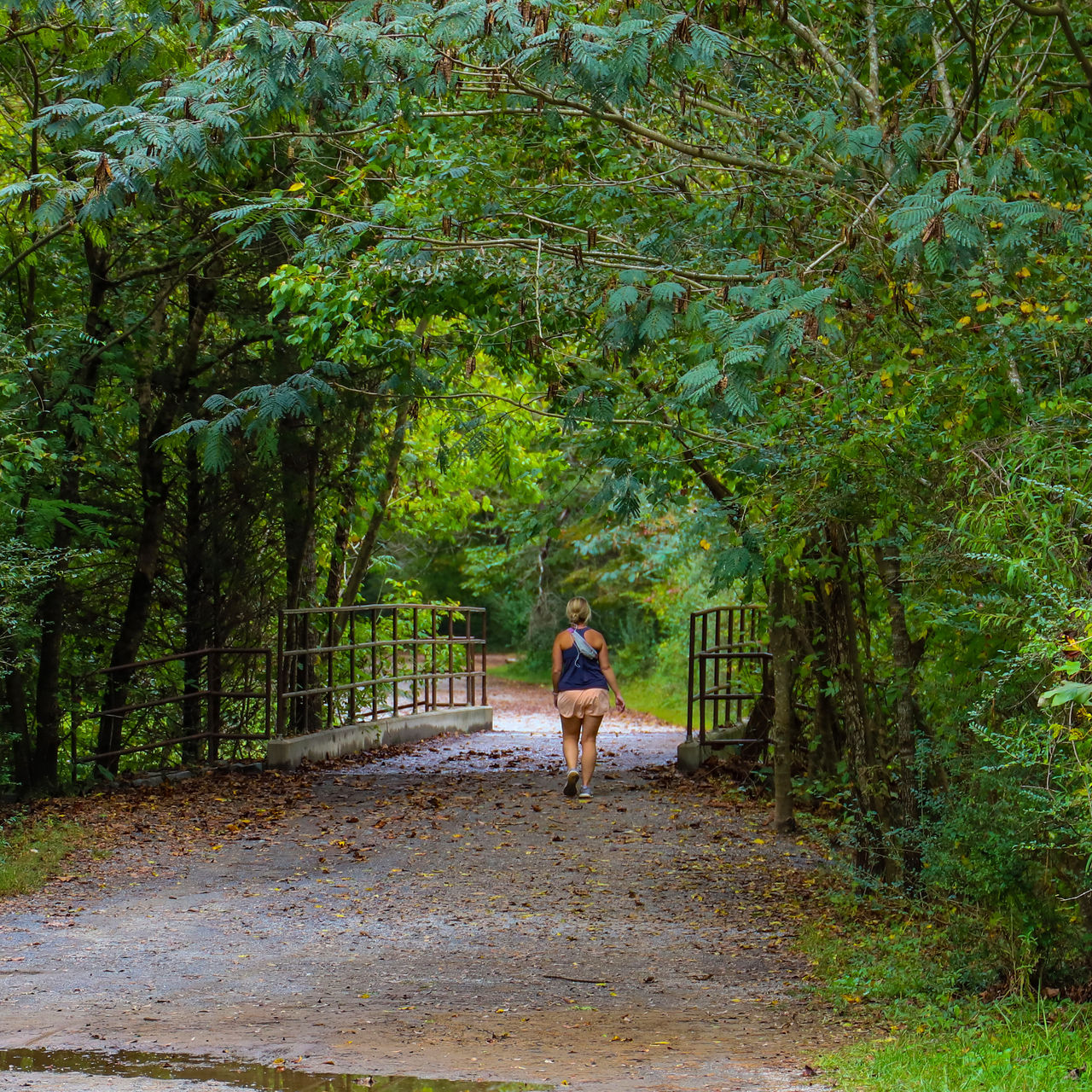 A woman on a dirt trail at Cochran Shoals trail in Georgia