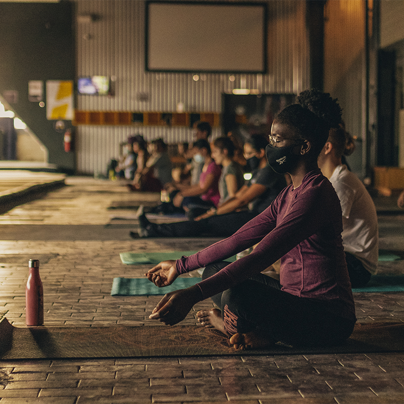 A woman practices in a yoga class at ASCEND Pittsburgh climbing gym
