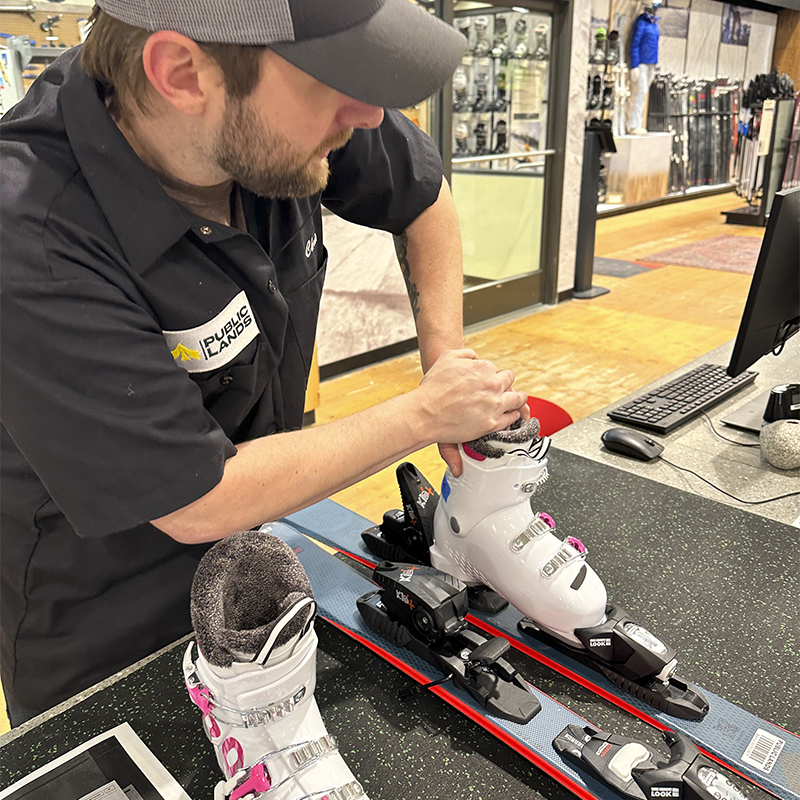Public Lands staff adjusts ski boots and binding