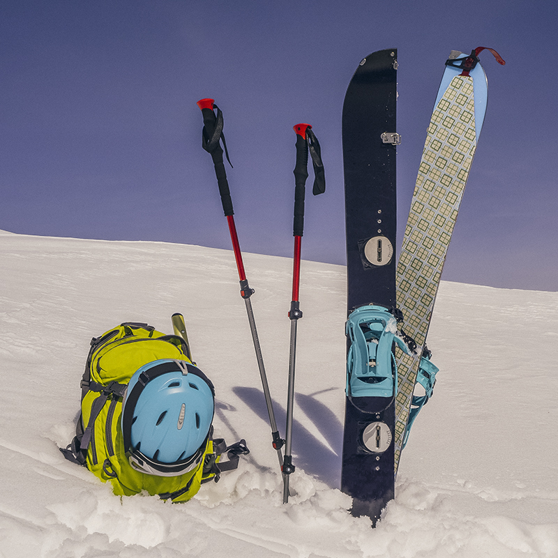 Splitboard halves, trekking sticks and backpack