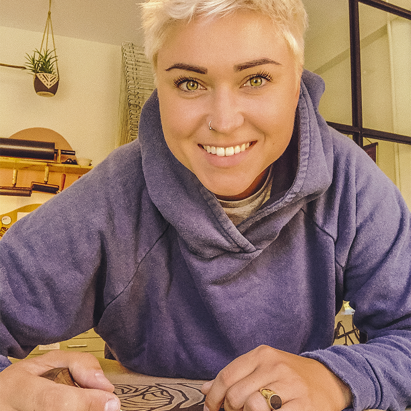A portrait of Erica Lang carving 