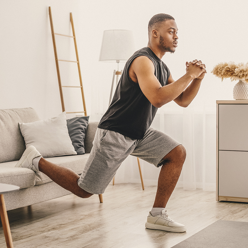 A man does Single-Leg Squats at his home