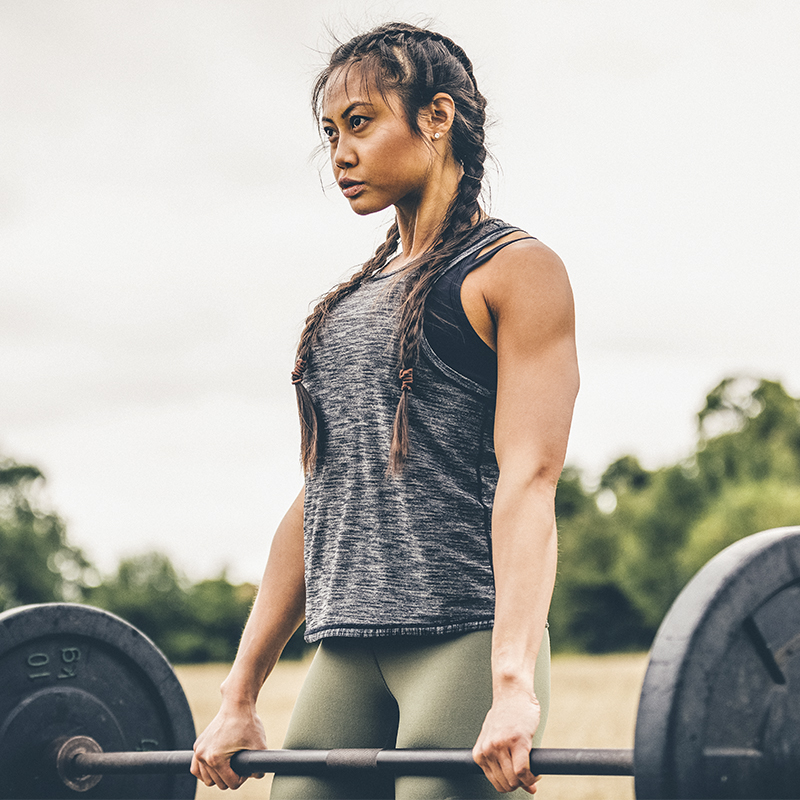 A woman lifts weights in a deadlift