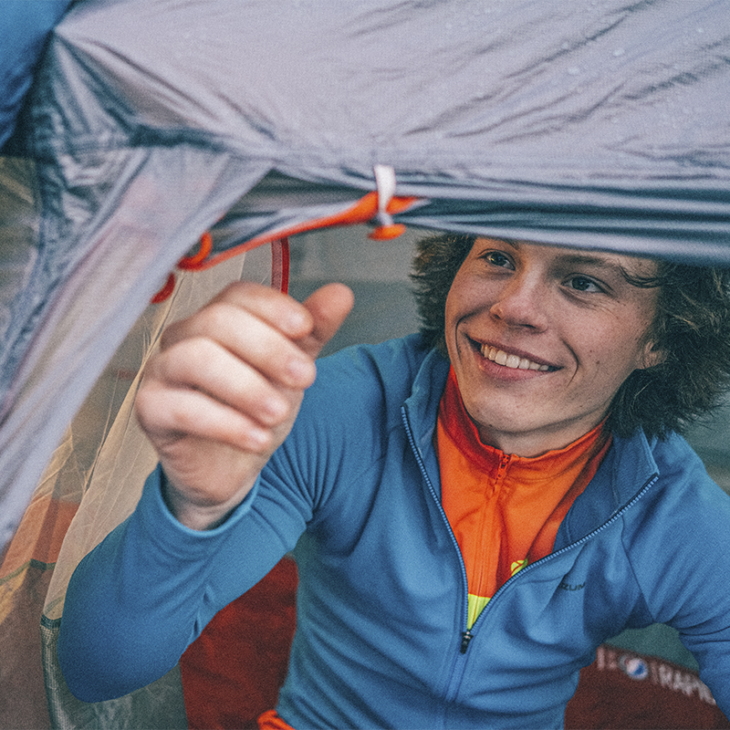 A man looks to close his tent