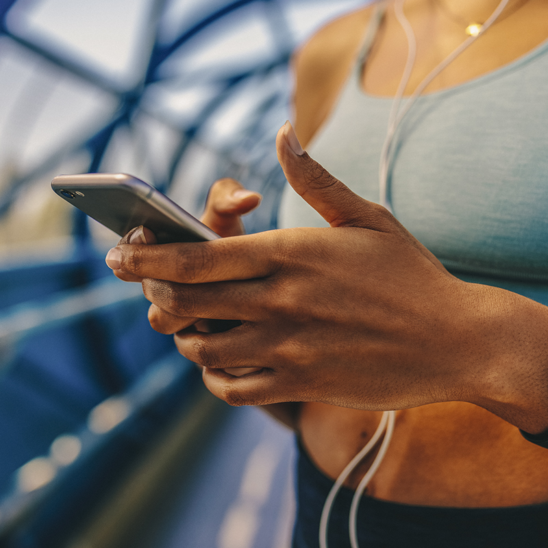 A person checks their phone when running